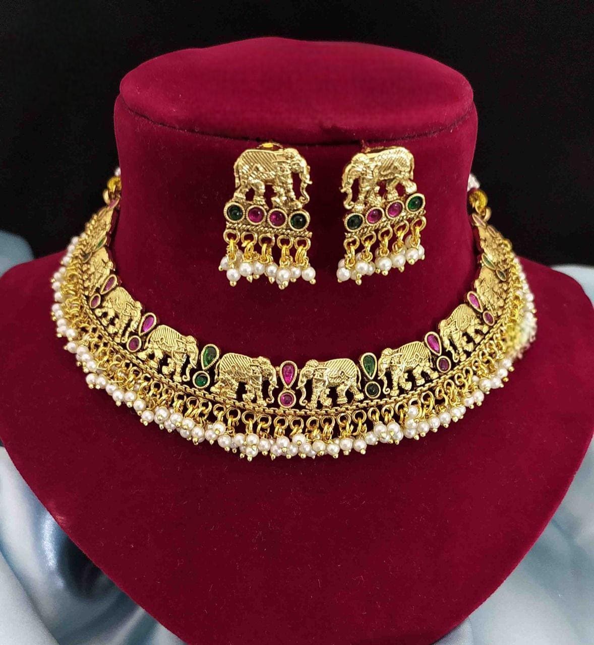 Short traditional gold necklace set with elephant design and pearls