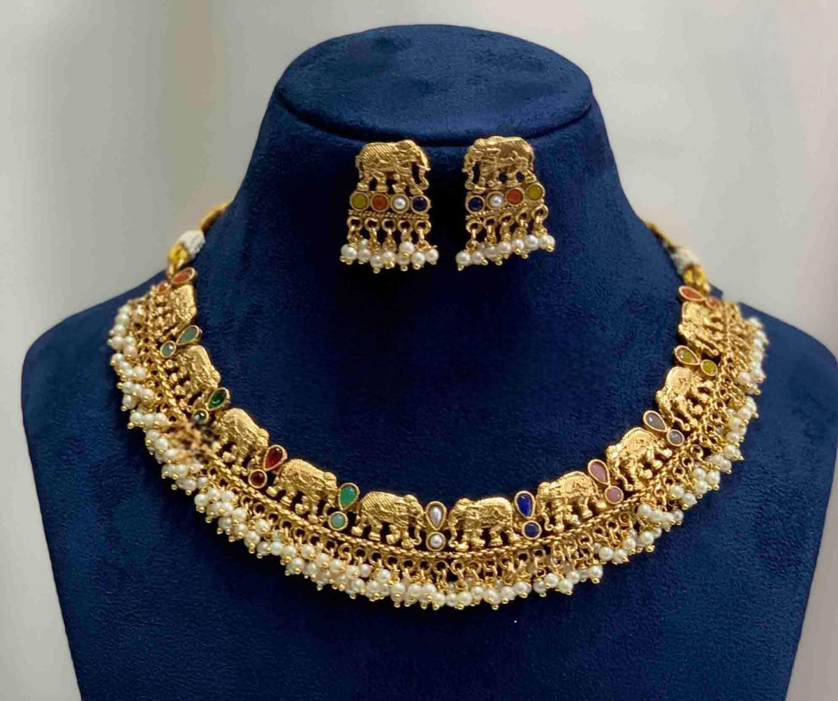 Short traditional gold necklace set with elephant design and pearls