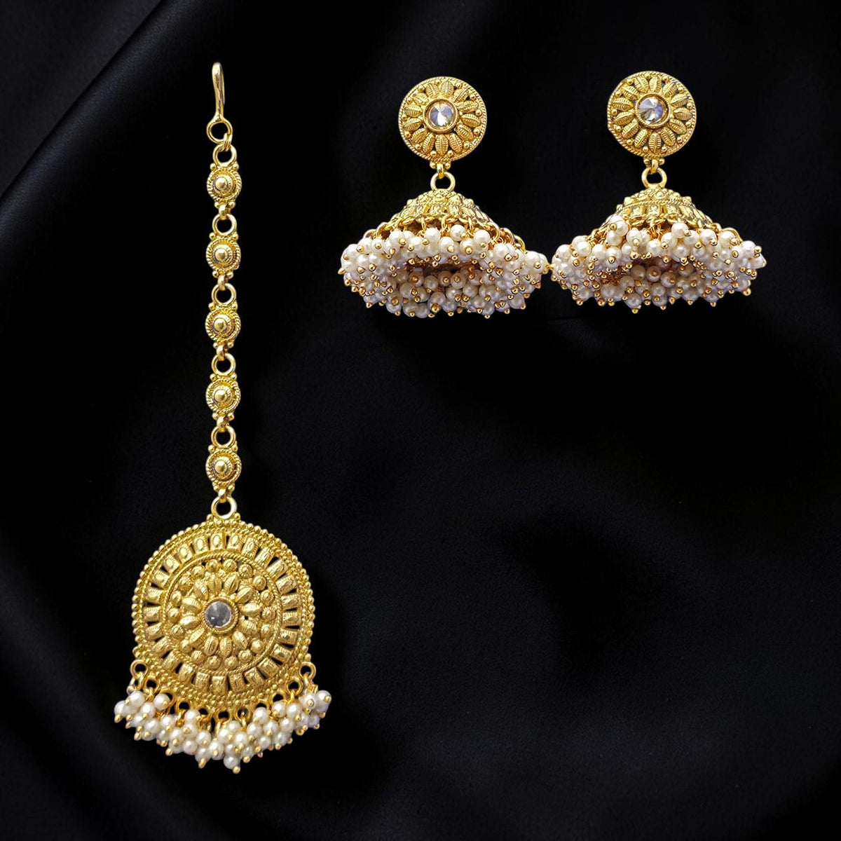 Small golden and pearl jhumkis with gold polished earrings with maang tikka